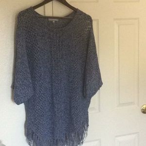 Blue sweater with fringe.